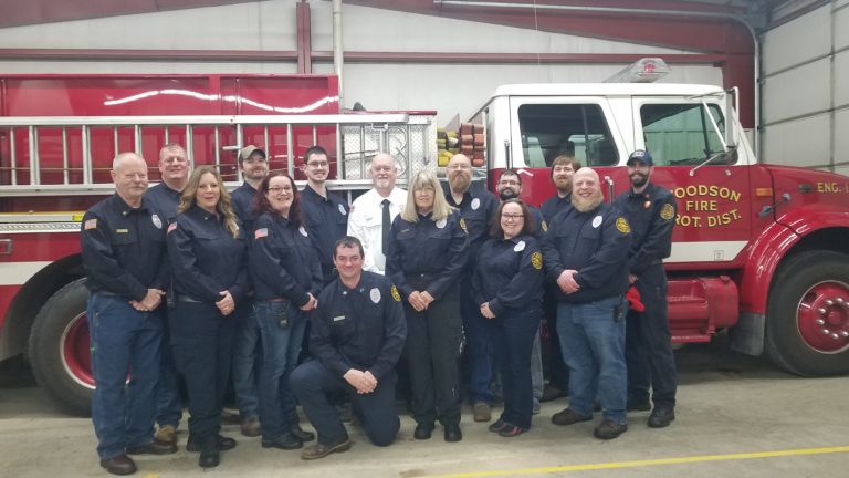 Woodson Fire Protection District members in front of a fire engine