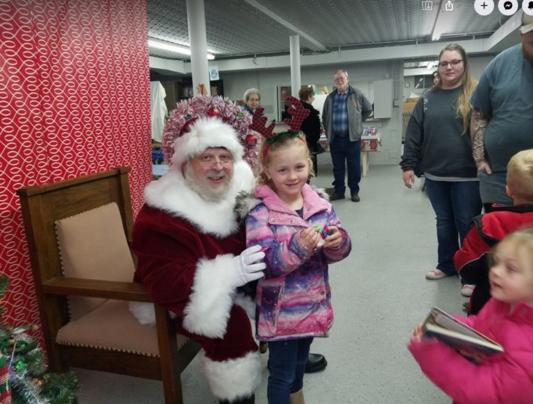 Santa Claus with a child at the village holiday event