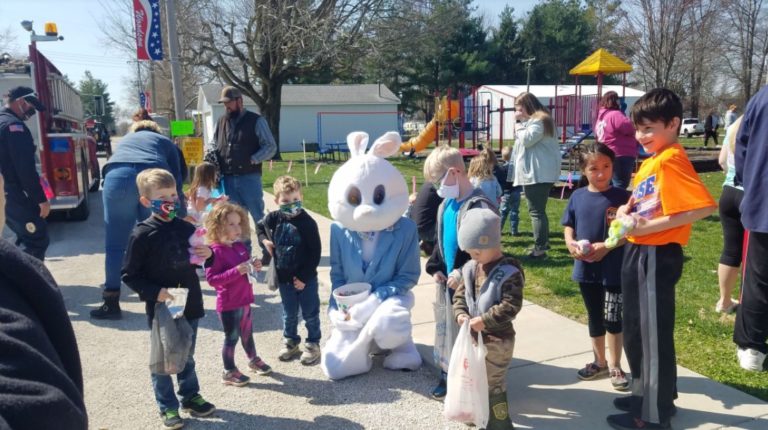 Children with the Easter Bunny on the sidewalk