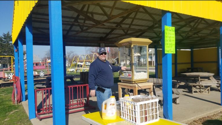 Volunteer making popcorn at the park pavilion