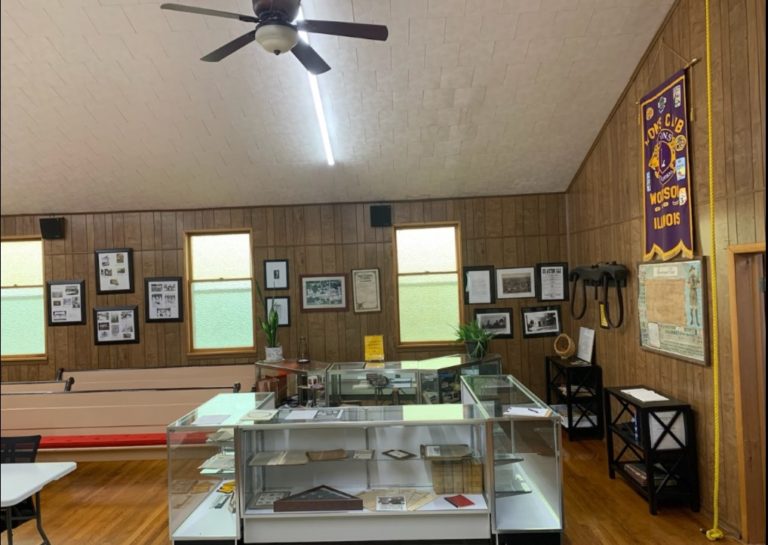 Display cases and framed photos inside Village Hall