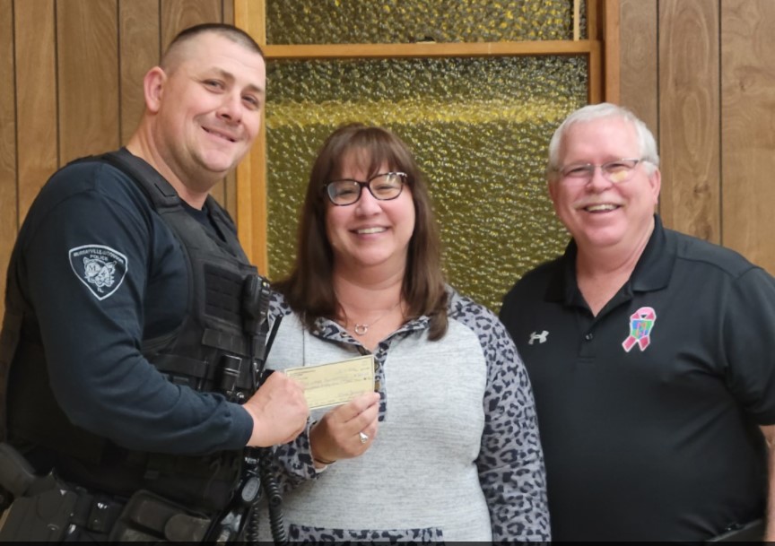 Officer presenting a community donation