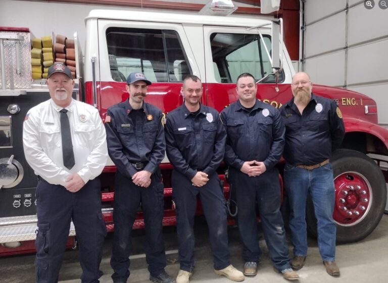 Five firefighters in front of a Woodson fire engine