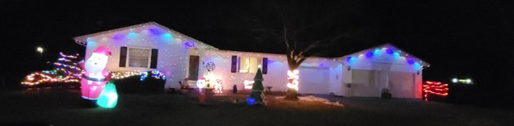 Home decorated with colourful holiday lights at night