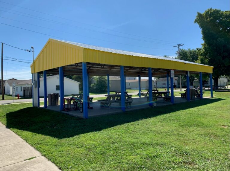 Park picnic pavilion with a yellow roof and blue posts